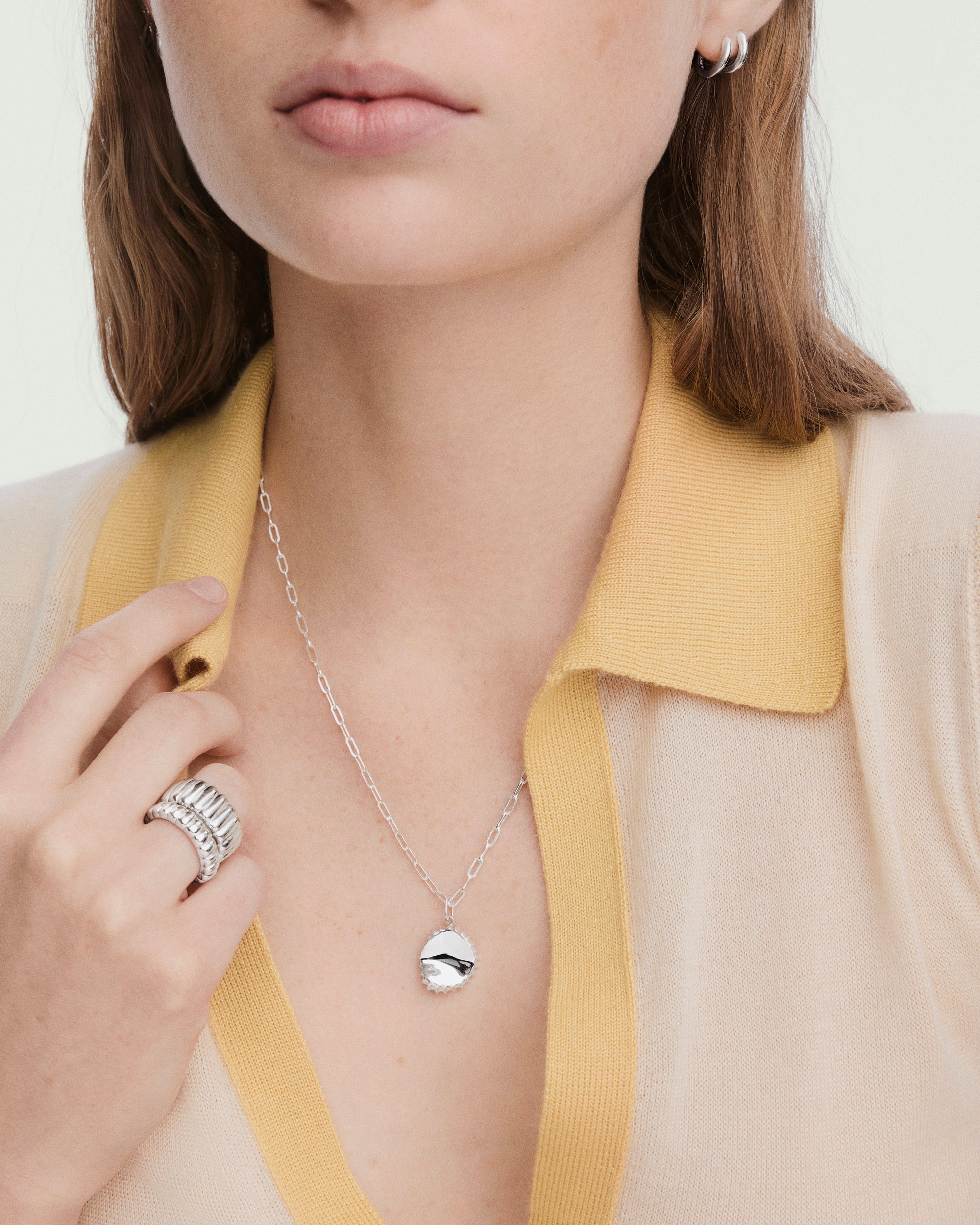 1-FoundObjects_CrushedBottleTopCharm_V_OnFig_044